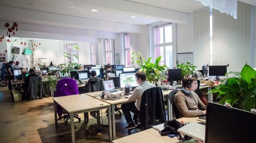 Tech startup workers in open plan office